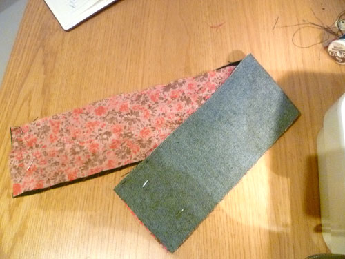 Red and pink floral fabric laid over denim fabric