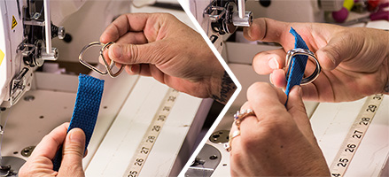 Blue webbing being threaded through gold D-rings