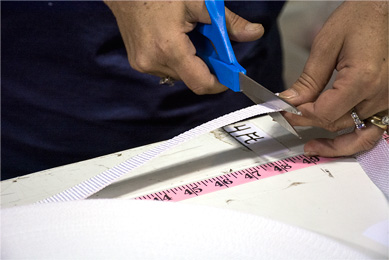 Webbing being cut to measured length