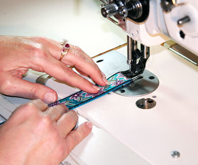 Webbing and ribbon being sewn together