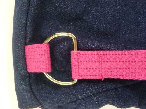 Pink strap sewn around gold D-ring