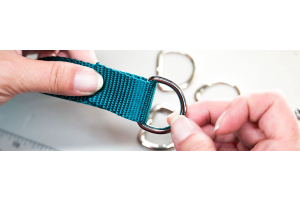 D-Ring being attached to teal nylon webbing