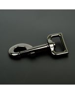 A dark gray gunmetal snap hook on a black background