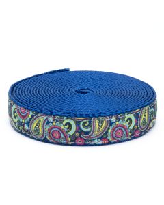 A dark blue grosgrain ribbon with brightly colored paisleys printed on it sewn onto a bright royal blue nylon webbing