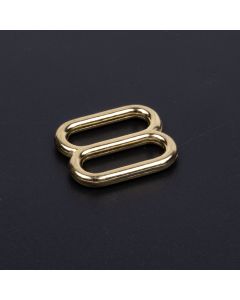 3/4 Inch Brass Plated Metal Round Triglide Slide with a black background