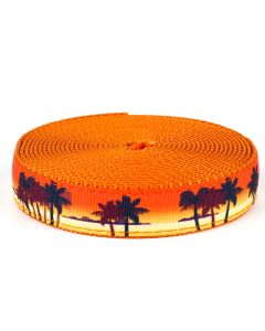 Palm trees swaying with a orange sunset in the back ground