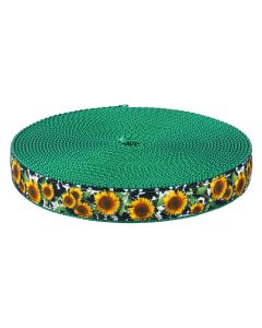 A roll of green webbing with a printed edge featuring a sunflower pattern on a black and white background.