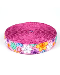 Pink grosgrain ribbon with retro 70s style florals printed on it sewn onto rose colored nylon webbing