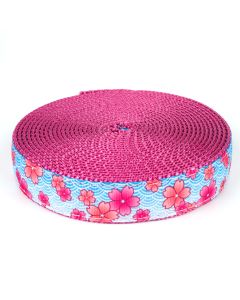 Blue grosgrain ribbon with pink flowers printed on it sewn onto a rose colored nylon webbing