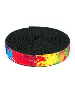 Bright, multi-colored grosgrain ribbon that looks like it's had different colors of paint splattered on it sewn onto black nylon webbing