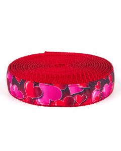 Pink and red hearts at different angles printed on grosgrain ribbon sewn onto red nylon webbing