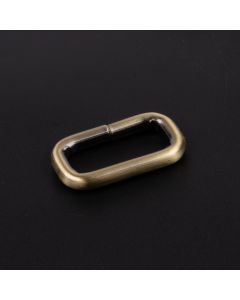 A single, 1 Inch Brushed Brass Heavy Welded Rectangle Ring shown on a dark background