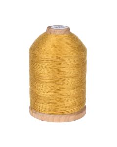 A spool of gold colored thread on a wooden spool