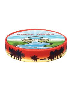 A roll of polyester webbing with a beachy sunset and palm trees printed onto it