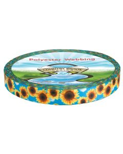 A roll of polyester webbing with a blue sky with fluffy clouds and sunflowers printed onto it