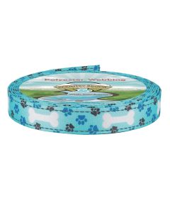 A roll of Country Brook Design polyester webbing featuring a teal background printed edge with white bones and paw prints.