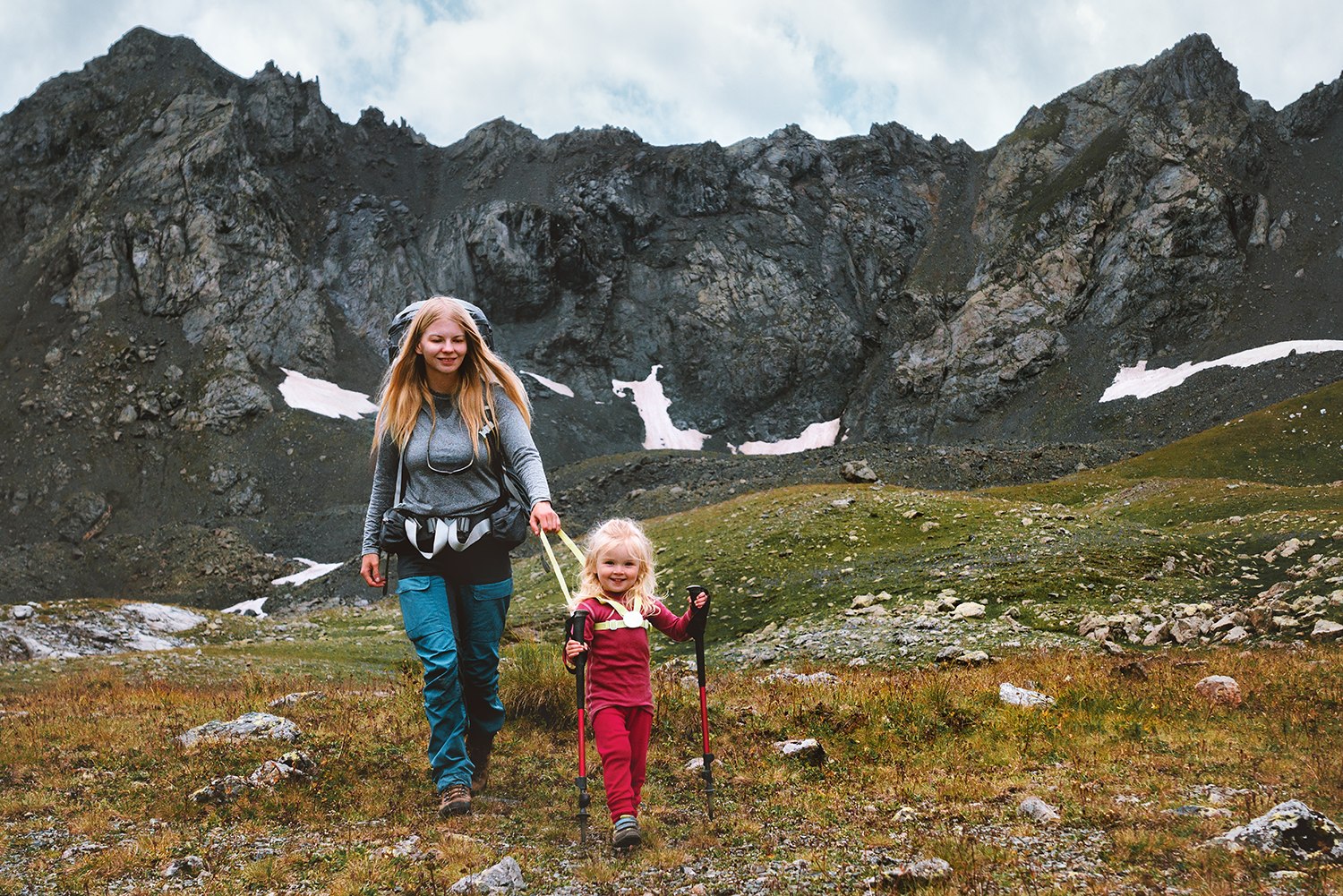 Mother and child hiking along a mountain trail
