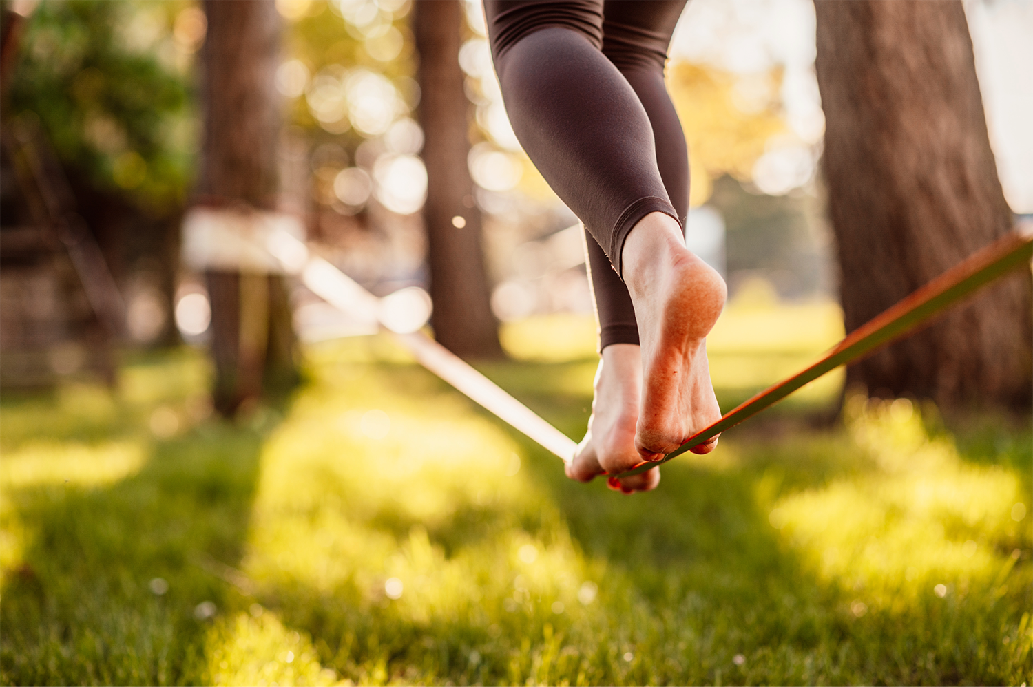 Acrobat balancing on an out-stretched slackline