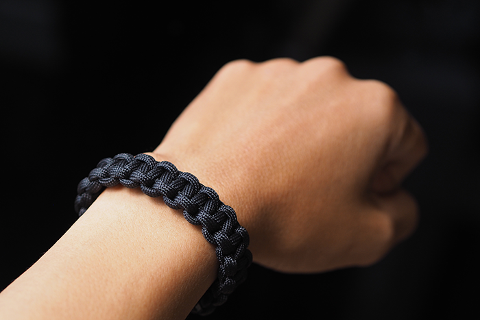 Black paracord wrapped around a wrist
