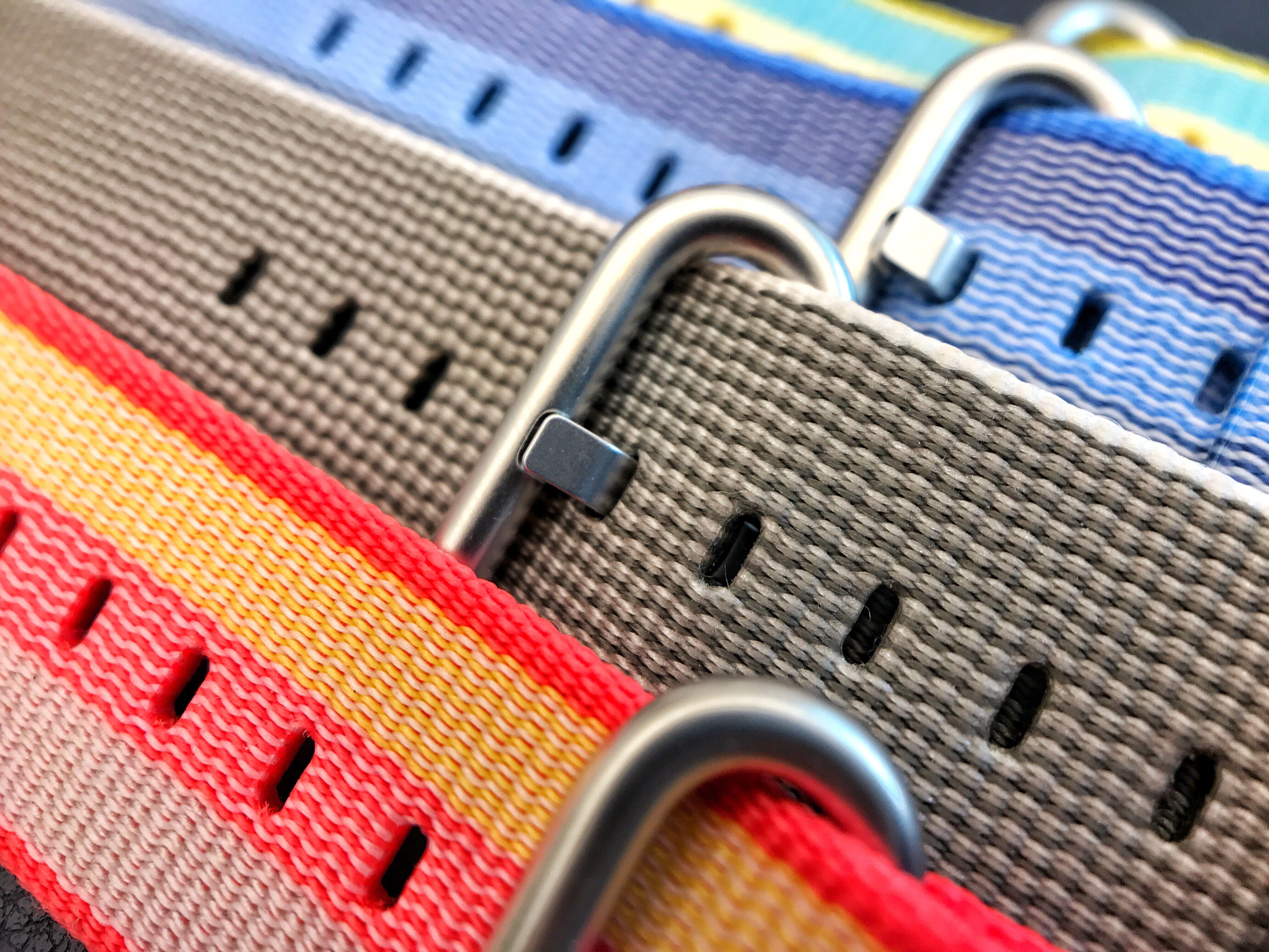 a row of nylon watch bands with buckles
