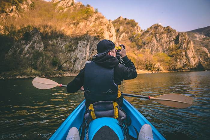 Man kayaking in a sparkling body of water