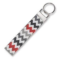 A closeup photo of a keyfob with a gray and red chevron pattern