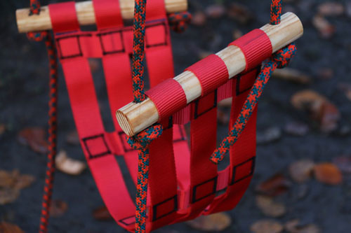 Swing made with red woven webbing